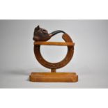 A Mid 20th Century Pipe Rack in the Form of Horseshoe Containing One Carved Bull's Head Pipe