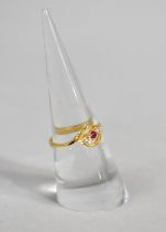 A Gold Ring with Central Ruby Flanked by Two White Stone, 2g, Size N