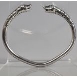 A White Metal Bangle with Dolphin Head Ends