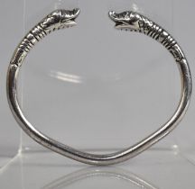 A White Metal Bangle with Dolphin Head Ends