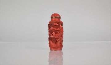A Cinnabar Lacquer and Gilt Metal Snuff Bottle of Cylindrical Form decorated with Figures in River