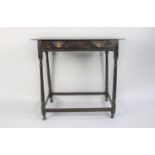 An Early 18th Century Country Made Oak Side Table with a Solid Plank Top Over a Frieze Drawer,