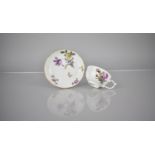 A Meissen Porcelain Cup and Saucer Decorated with Floral Bursts and With Gilt Trim on White Ground