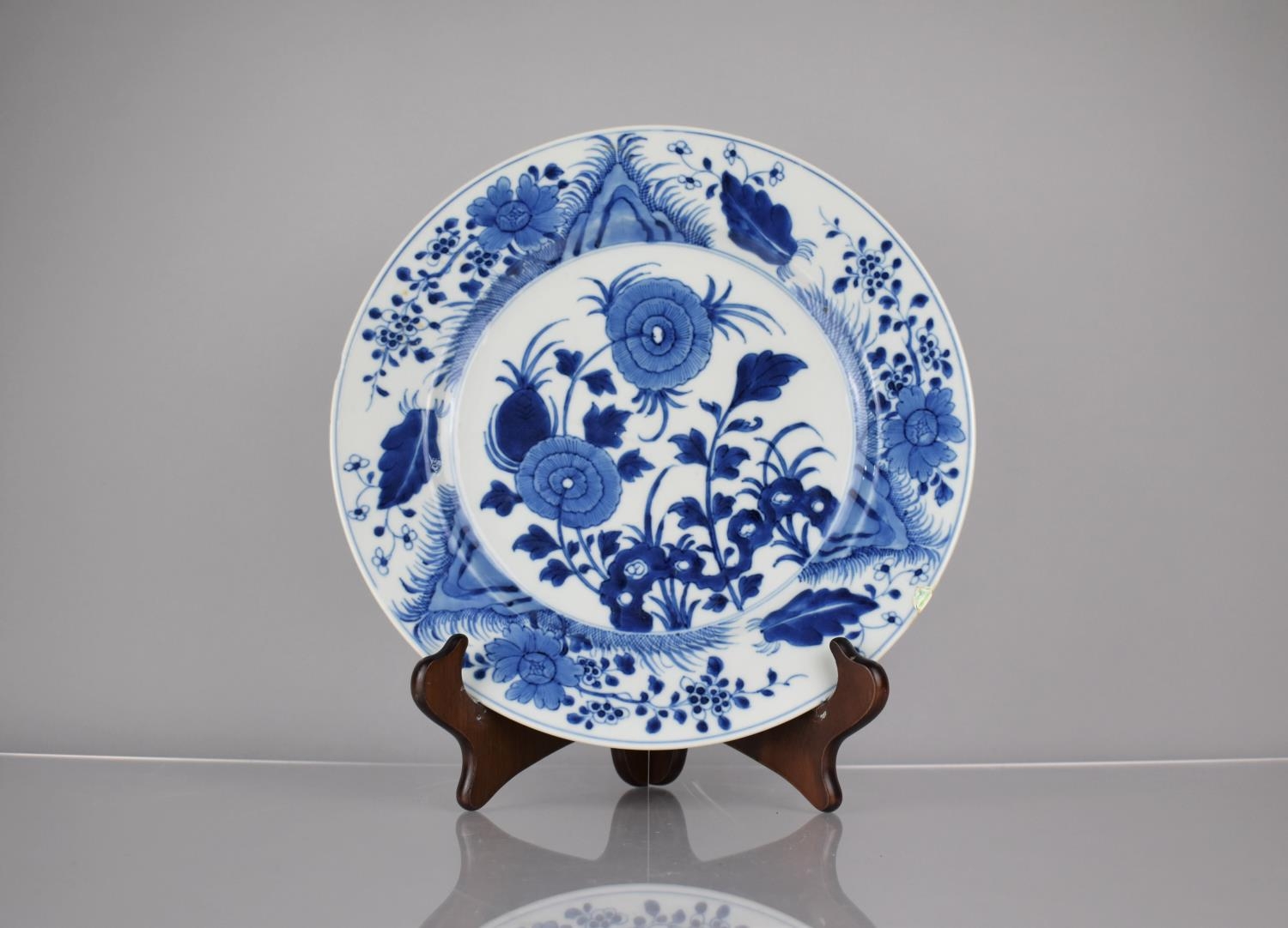 A 19th Century Chinese Porcelain Blue and White Plate Decorated in a Floral Motif, the back with