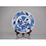 A 19th Century Chinese Porcelain Blue and White Plate Decorated in a Floral Motif, the back with