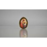 A Russian Porcelain Easter Egg decorated with Hand Painted Cartouche of the Virgin Mary and Christ