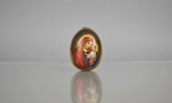 A Russian Porcelain Easter Egg decorated with Hand Painted Cartouche of the Virgin Mary and Christ