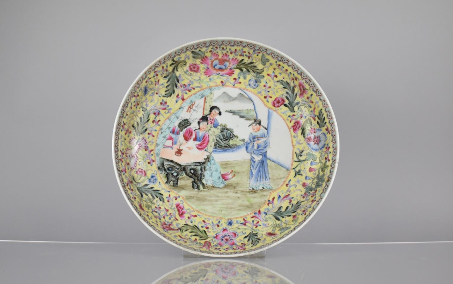A 20th Century Chinese Porcelain Yellow Ground Charger Decorated in the Famille Rose Palette with