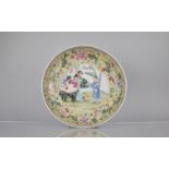 A 20th Century Chinese Porcelain Yellow Ground Charger Decorated in the Famille Rose Palette with