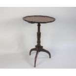 An Early George III Mahogany Tripod Wine Table with a Carved Pie Crust Top over a Turned Stem and