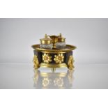 A Regency Bronze and Gilt Ink Stand of Circular Footed Form complete with Two Cut Glass Inkwells