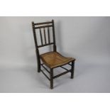 A 19th Century Slipper Chair with Bobbin Turned Back over a Caned Seat, 80cms High