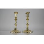 A Pair of 18th Century George III Brass Candlesticks with Shaped Stems over Wavey Rococo Bases,