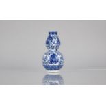 A Chinese Blue and White Porcelain Double Gourd Vase Decorated in a Floral Motif, Blue Seal Mark