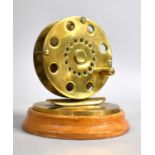 An Early/Mid Brass Novelty Desktop Paperweight in the Form of a Fly Fishing Reel on Circular