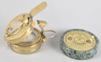 A Reproduction Brass Prismatic Compass together with a Brass 100 Year Calendar on Polished Stone