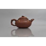 A Late 19th Century Yixing Teapot of Shaped Form with Stylised Handle in the Form of Entwined