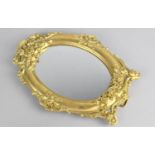 A Gilt Bronze Framed Oval Easel Back Mirror with Floriate Decoration in Relief, 24cms High