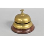 A Modern Brass Countertop Reception Bell on Turned Wooden Plinth, 11cms Diameter