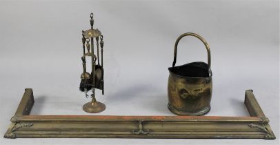 A Vintage Brass Fire Kerb, Brass Companion Set and Helmet Shaped Coal Scuttle