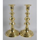 A Pair of Victorian Polished Brass Candlesticks with Pushers, 23.5cms High