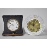 A Vintage Folding Travel Alarm Clock together with a Circular Tyrone Lead Crystal Mantel Clock