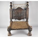 A Late 19th Century North African or Moroccan Hand Carved Hardwood Low Chair with Hide Stringing and