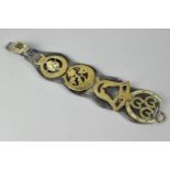 A Vintage Leather Martingale Strap Containing Four Horse Brasses, 45cms Long