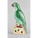 A Late 19th Century Chinese Porcelain Export Famille Verte Parrot Perched on Open Rocky Base.