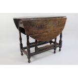 A 19th Century Oak Drop Leaf Gate Leg table with Oval Top, Turned Supports, 92cms Long