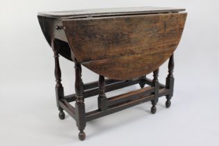 A 19th Century Oak Drop Leaf Gate Leg table with Oval Top, Turned Supports, 92cms Long