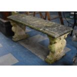 A Reconstituted Stone Garden Bench with Rectangular Top Supported on Sphynx Bases, 125cms Wide