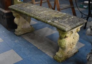 A Reconstituted Stone Garden Bench with Rectangular Top Supported on Sphynx Bases, 125cms Wide