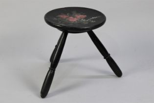 A Circular Ebonised Three Legged Dish Topped Stool with Painted Floral Decoration, 30cms Diameter