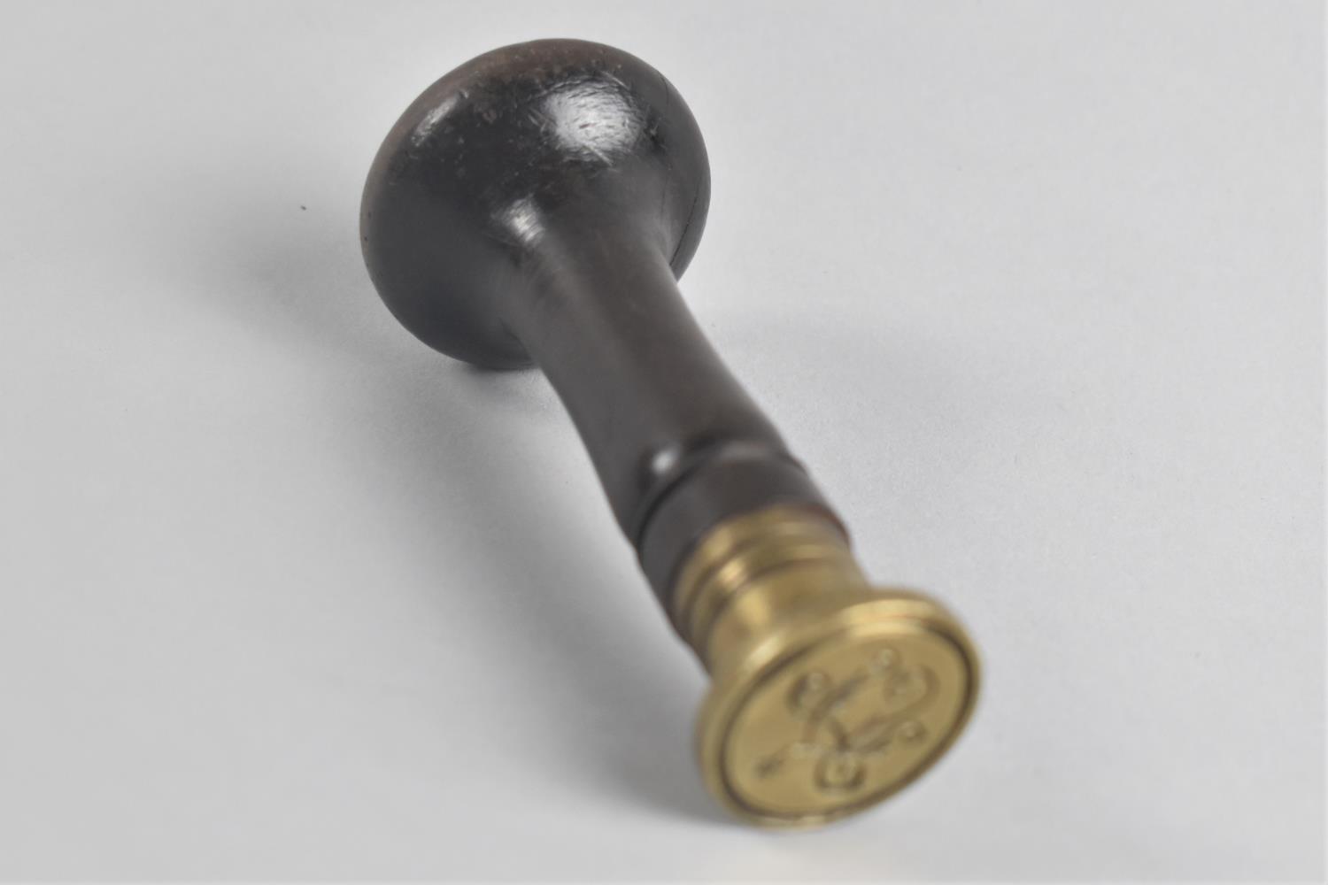 A 19th Century Mahogany and Brass Monogramme Seal, 9.5cms Long