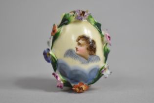 A 19th/20th Century Russian Porcelain Easter Egg with Encrusted Bocage and with Hand Painted