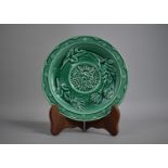 A 19th Century Majolica Green Glazed Plate Decorated in Shallow Relief with Central Floral Motif and