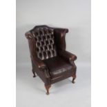 A Leather Effect Buttoned Back Wing Armchair