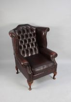 A Leather Effect Buttoned Back Wing Armchair