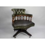 A Modern Green Leather Upholstered Swivel Office Chair with Button Back Rest and Turned Spindles