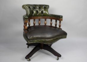 A Modern Green Leather Upholstered Swivel Office Chair with Button Back Rest and Turned Spindles