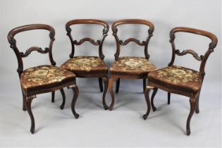 A Set of Four Victorian Mahogany Balloon Back Dining Chairs with Upholstered Floral Patterned Seats