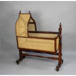 A Re-caned Late Victorian Mahogany Framed Bergere Cradle, 104cms Long and 122cms High