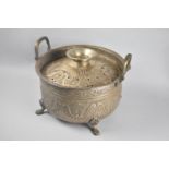 An Indian Pressed Metal Temple Censer with Two Carrying Handles and Four Scrolled Feet, 32cms