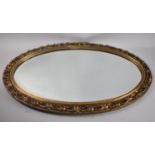 An Oval Ornate Gilt Framed Bevel Edge Wall Mirror, 75x47cm