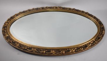 An Oval Ornate Gilt Framed Bevel Edge Wall Mirror, 75x47cm