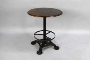 An Iron Based Circular Topped Pub Table with Four Moulded Claw Feet, 59cms Diameter and 70cms High