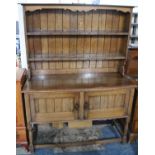 An Oak Sideboard with Panelled Cupboard Base Raised on Turned Supports and Having Two Tier Rack,