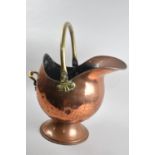 A Vintage Copper and Brass Helmet Shaped Coal Scuttle with Loop Handle, 50cms High