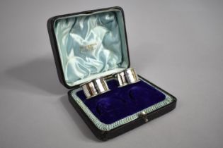 A Walker & Hall Fitted Case for Four Napkin Rings, Containing Only Two Silver Napkin Rings, Nos. 1 &